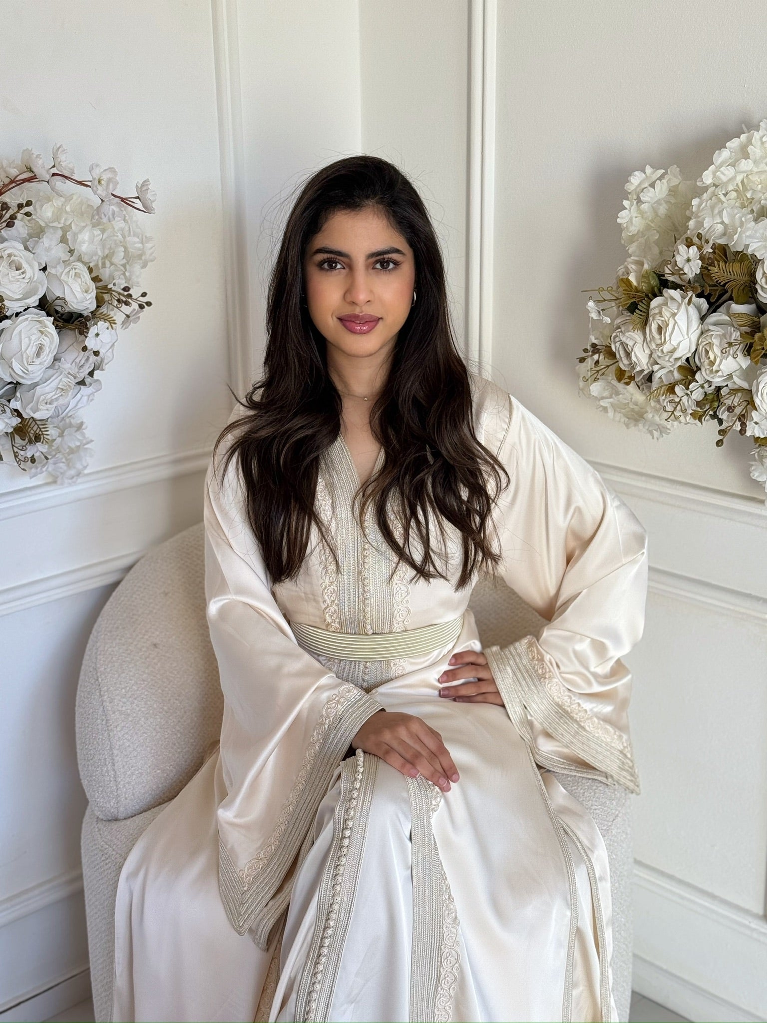 Woman wearing the Takchita Naziha, a luxury handmade Moroccan takchita with elegant flowing layers.