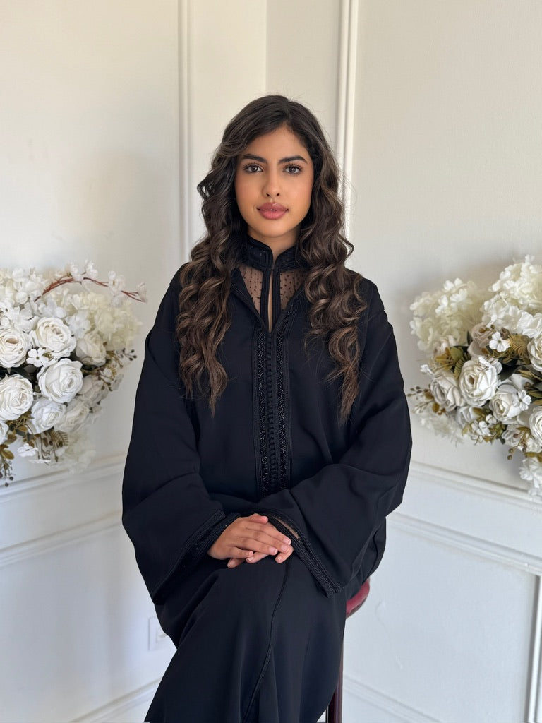 Model wearing Jellaba Sana – black Moroccan jellaba with subtle embroidery