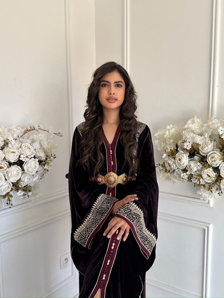Model wearing Caftan Lina – burgundy velvet Moroccan caftan with gold embroidery