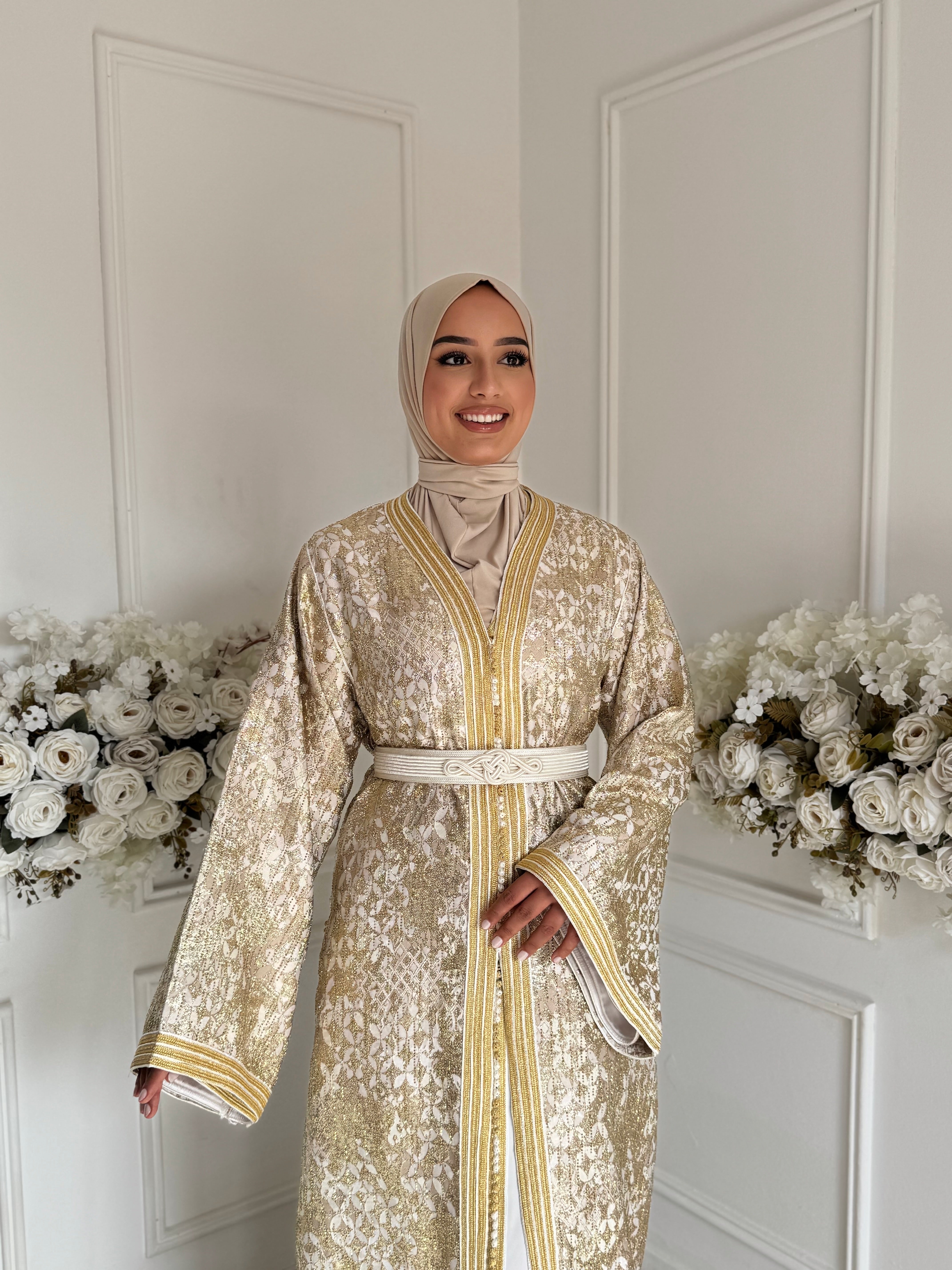 Model wearing Takchita Aya – golden Moroccan takchita with hand embroidery and belt