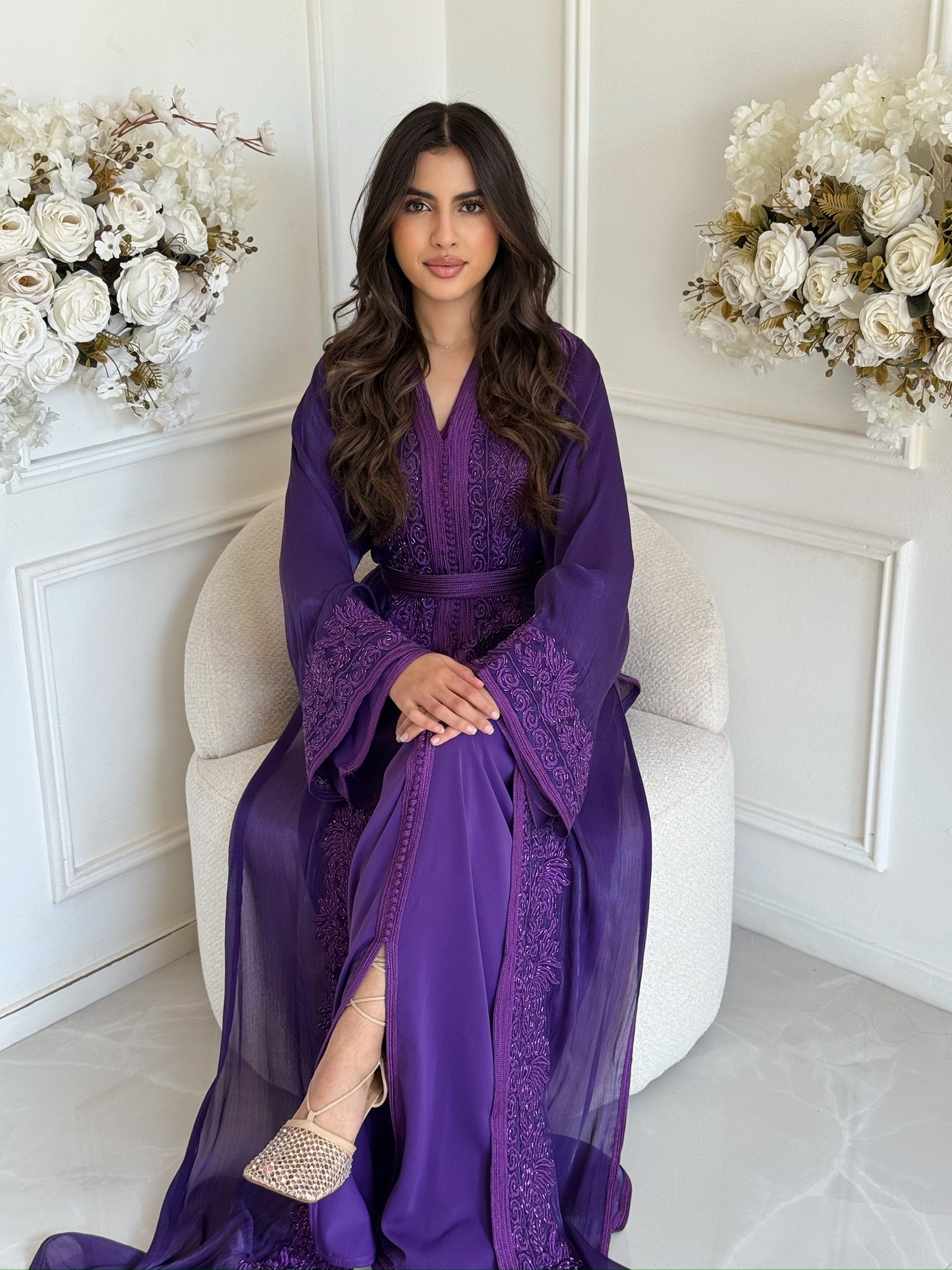 Full-length purple takchita with flowing sleeves and embroidered details in a white interior