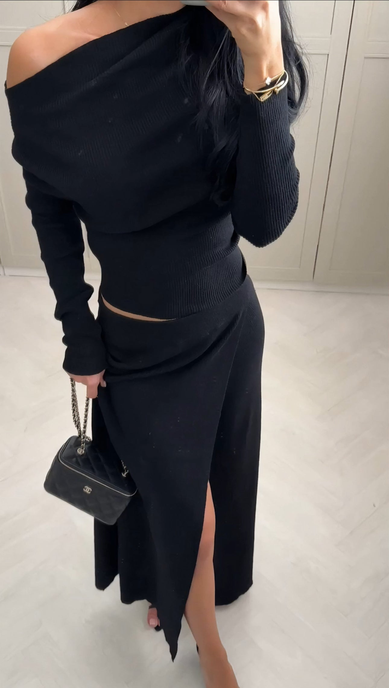 Black Roza off-shoulder dress styled as a timeless evening look