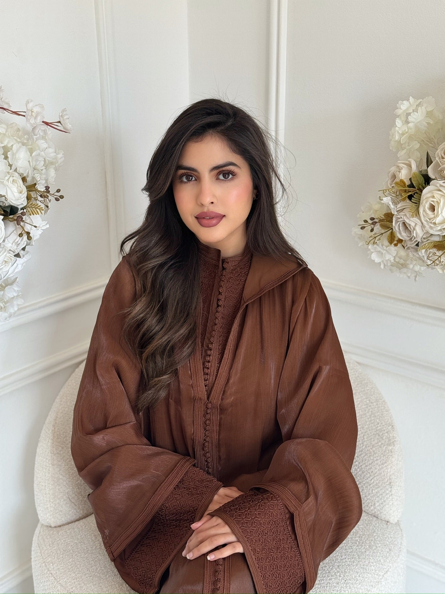 “Model wearing brown velvet Jellaba Amaani caftan with elegant embroidery, luxury Ramadan and Eid outfit”