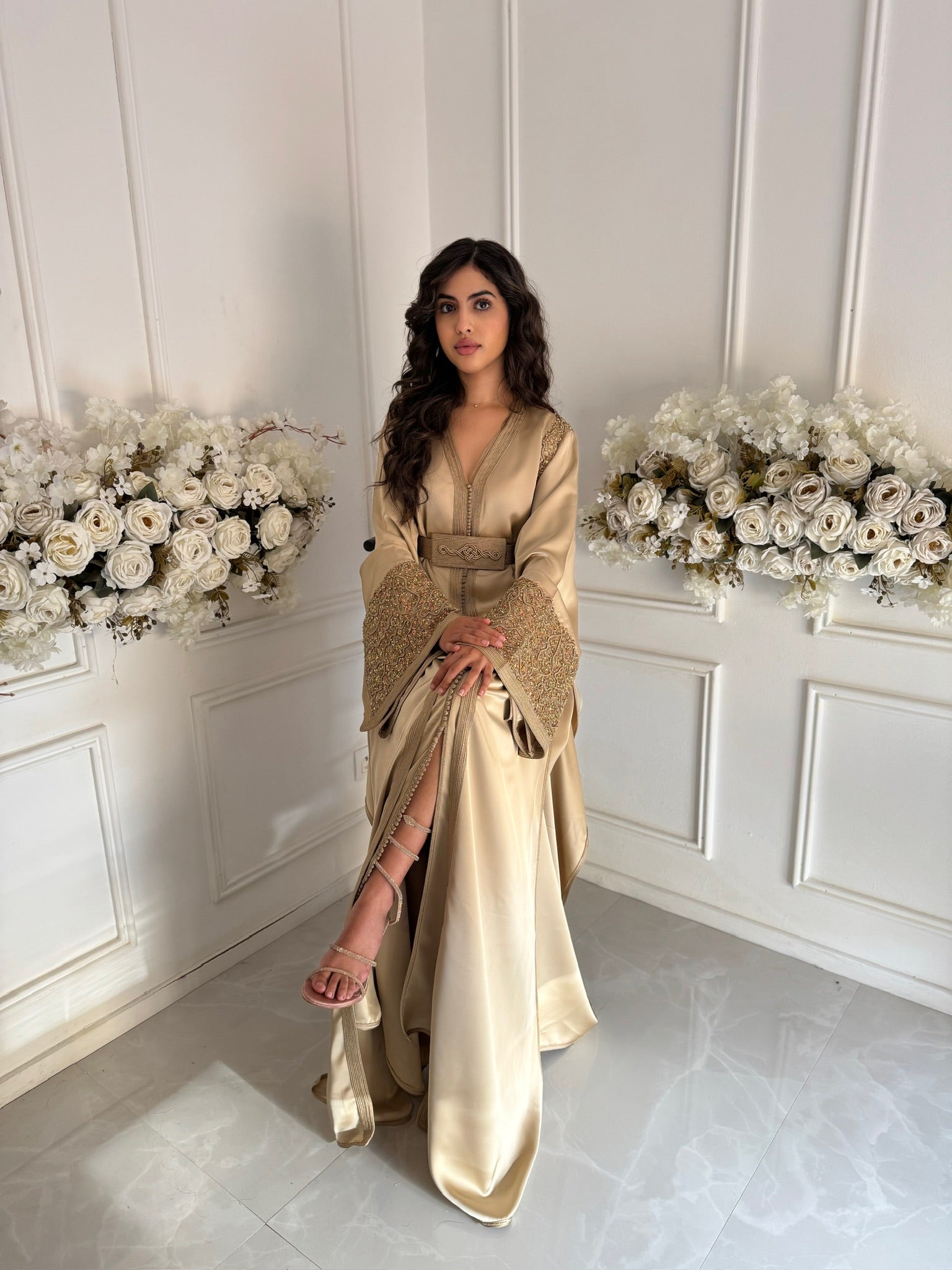 Model wearing gold Moroccan takchita Layla with embroidered sleeves