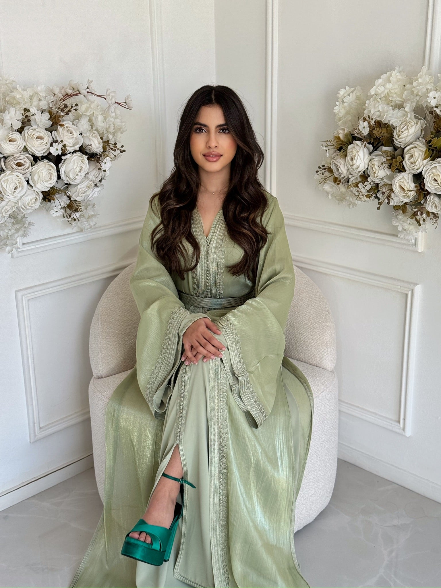 Full-length soft green Moroccan takchita with flowing sleeves and elegant detailing